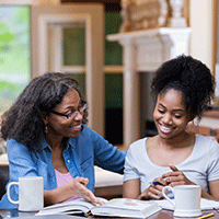 Woman with coffee cup smiling with student