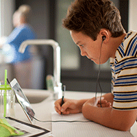 Young male student taking notes