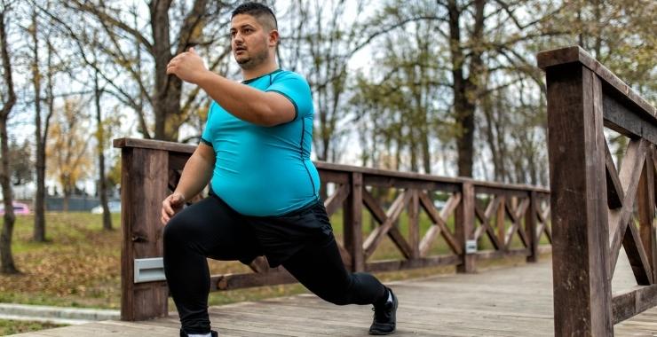 Man stretching and exercising in the park.