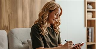 psychologist taking notes during session with patient