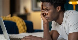teen boy using AI on laptop