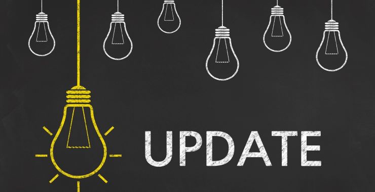 Chalkboard drawings of lightbulbs with the word Update written next to a large yellow bulb