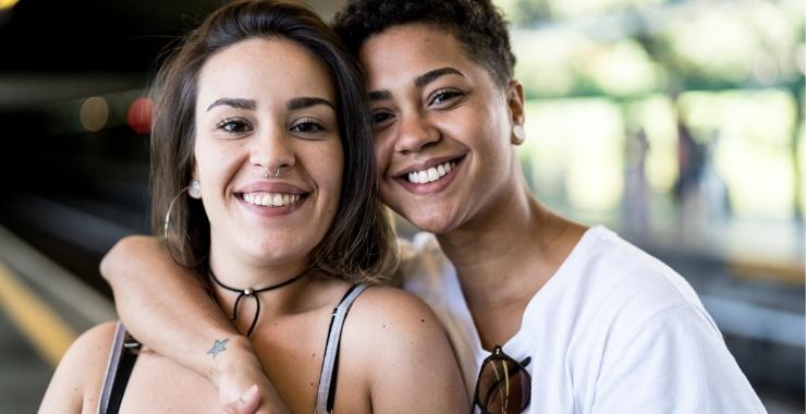 Two teens hugging and smiling.
