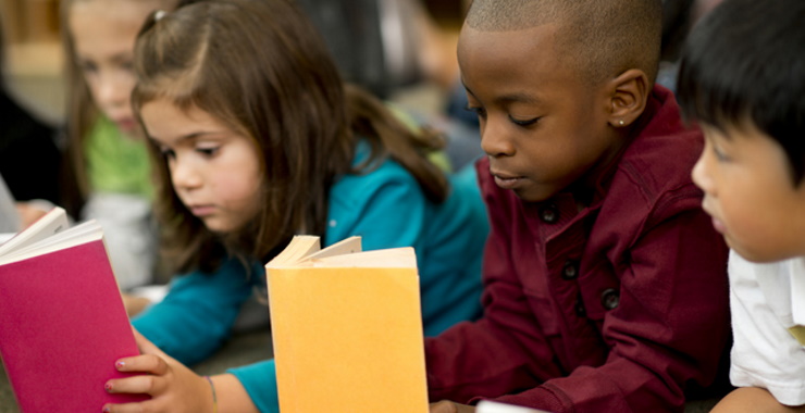 young children holding books