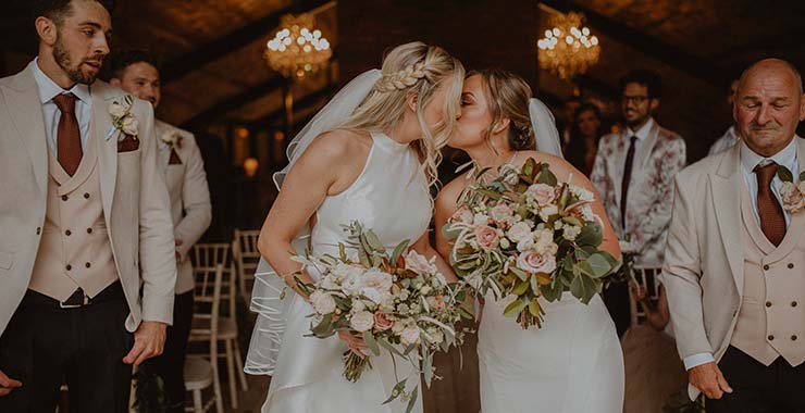 two women kissing during their wedding ceremony