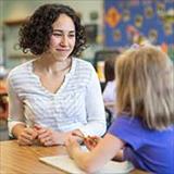 teacher and young girl in classroom