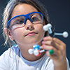 Girl looking at a science model