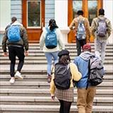 students walking into an academic building