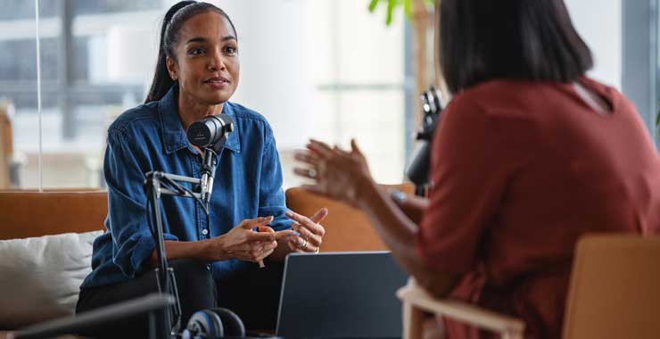 two women doing an interview for a podcast