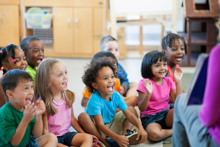 teacher reading book to children