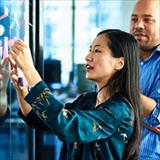 woman and man working at whiteboard