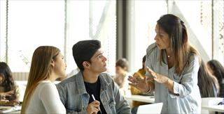 Mature teacher with students in a classroom