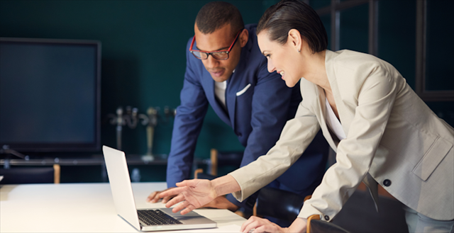 Two colleagues looking at computer screen