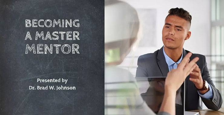 Young male professional looks intently at fellow professional as she speaks.