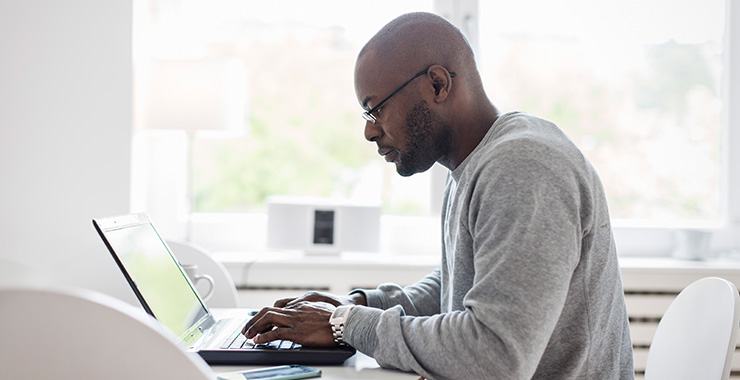 man sitting at a laptop