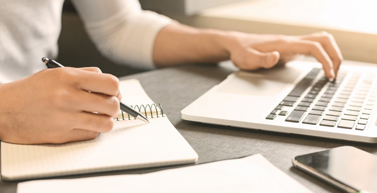 Image of hands taking notes