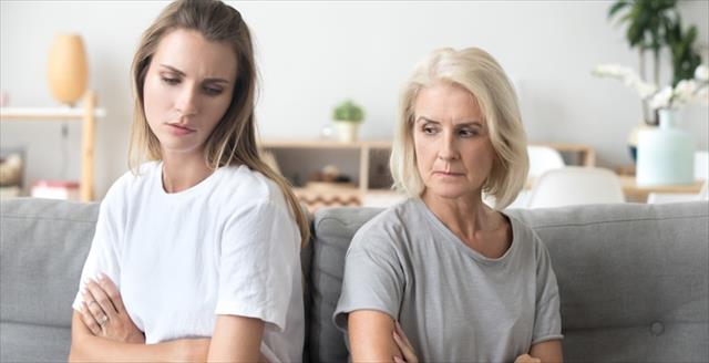 Daughter and mother with arms crossed