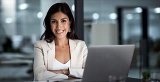 Woman smiling near laptop
