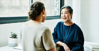 Doctor consulting with woman in office for healthcare