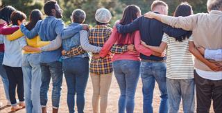 Rearview of diverse people hugging each other