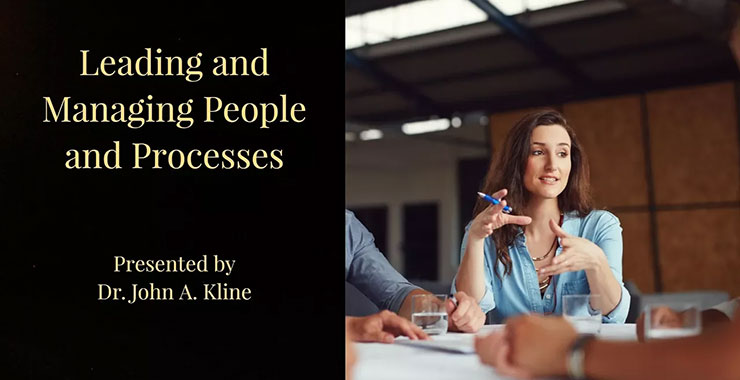 Middle aged professional woman leads meeting discussion.
