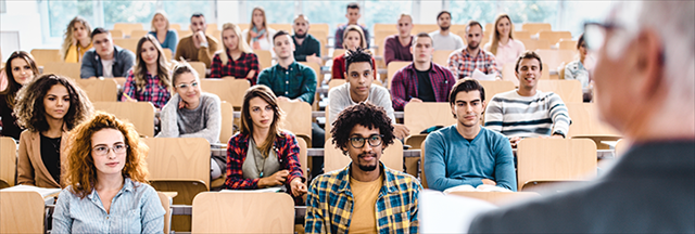 Group of students in classroom listening to instructor