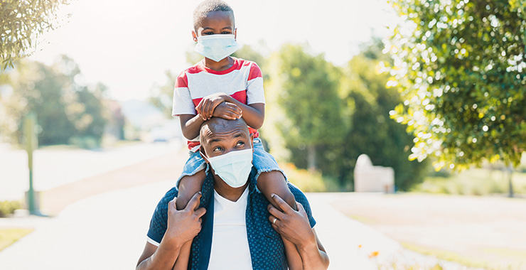 Black dad and son wearing masks