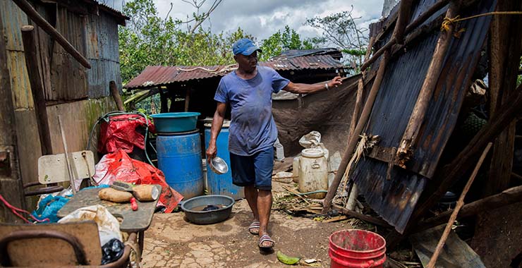 Man cleaning up after hurricane