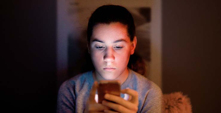 Teenage boy looking at cell phone