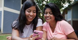 Mom and teen daughter looking at smartphone