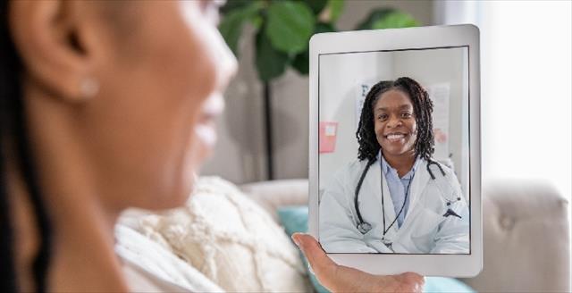 woman speaking with a doctor during a telemedicine session