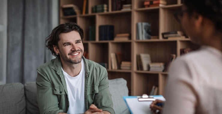 Man sitting on a couch and smiling
