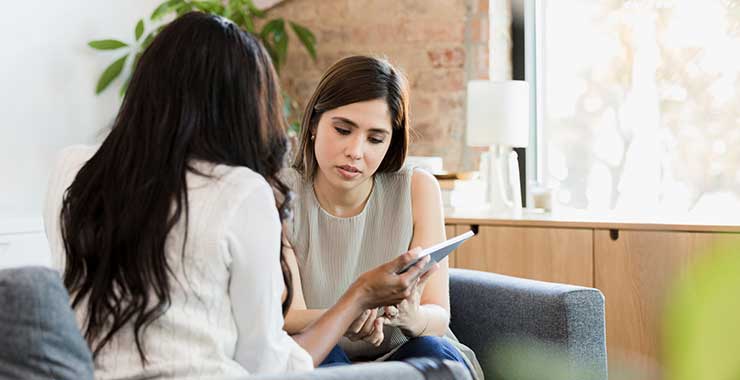 A psychologist and patient looking at a digital tablet