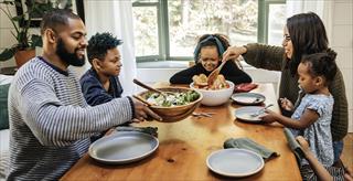 A family gathered around the dinner table, sharing a meal