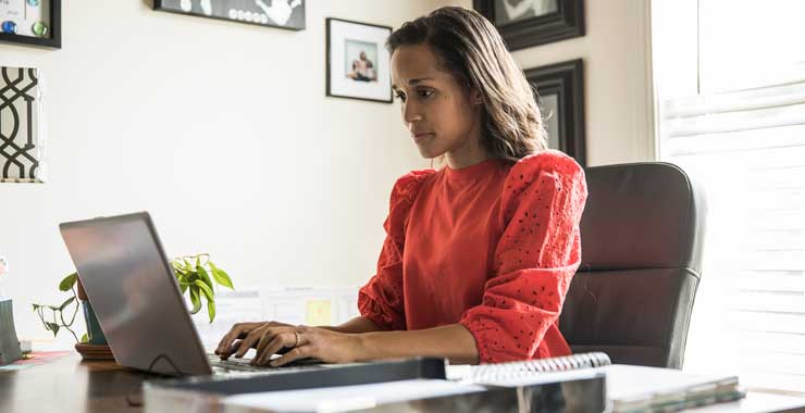 Woman at desk working on laptop