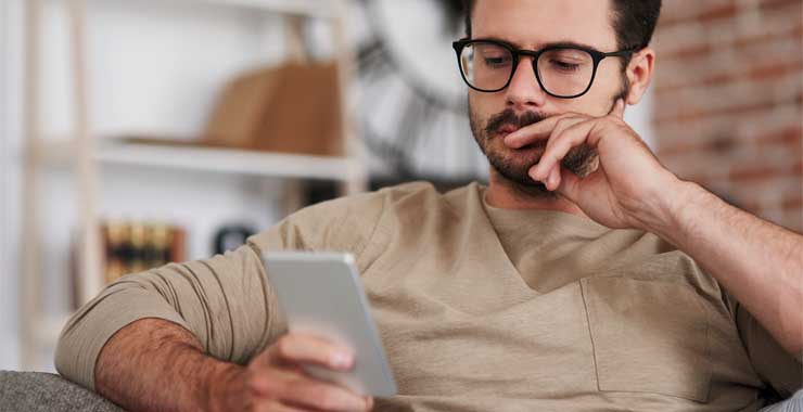A man holding and looking at his smartphone