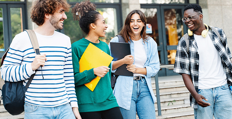 A group of college students walking together and laughing.