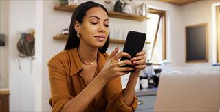 Young businesswoman looking at smartphone.
