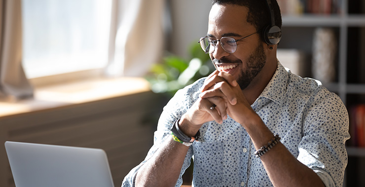 Man smiling at computer