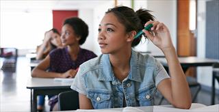 Female student holding a pen