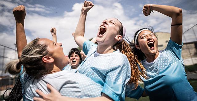 Happy female soccer team celebrating