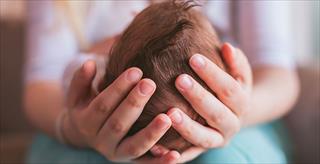 Mother holding newborn baby boy