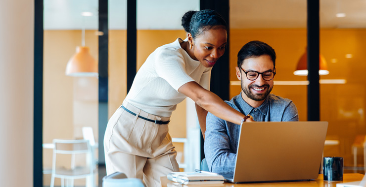 woman and man using a laptop