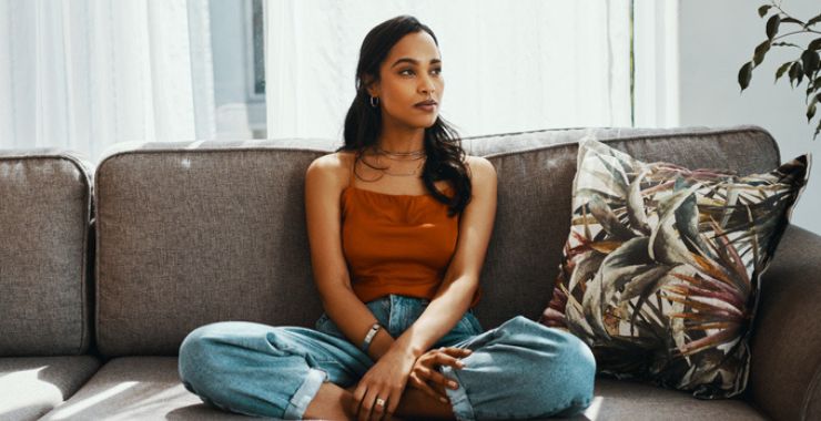 Young woman sitting on her sofa