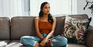 Young woman sitting on her sofa