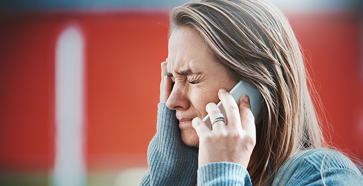Lady on cell phone appearing stressed out
