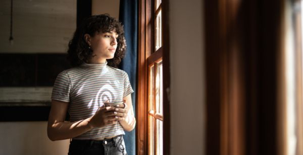 transgender woman looking out the window