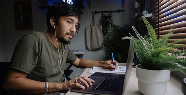 Young Asian man using laptop computer