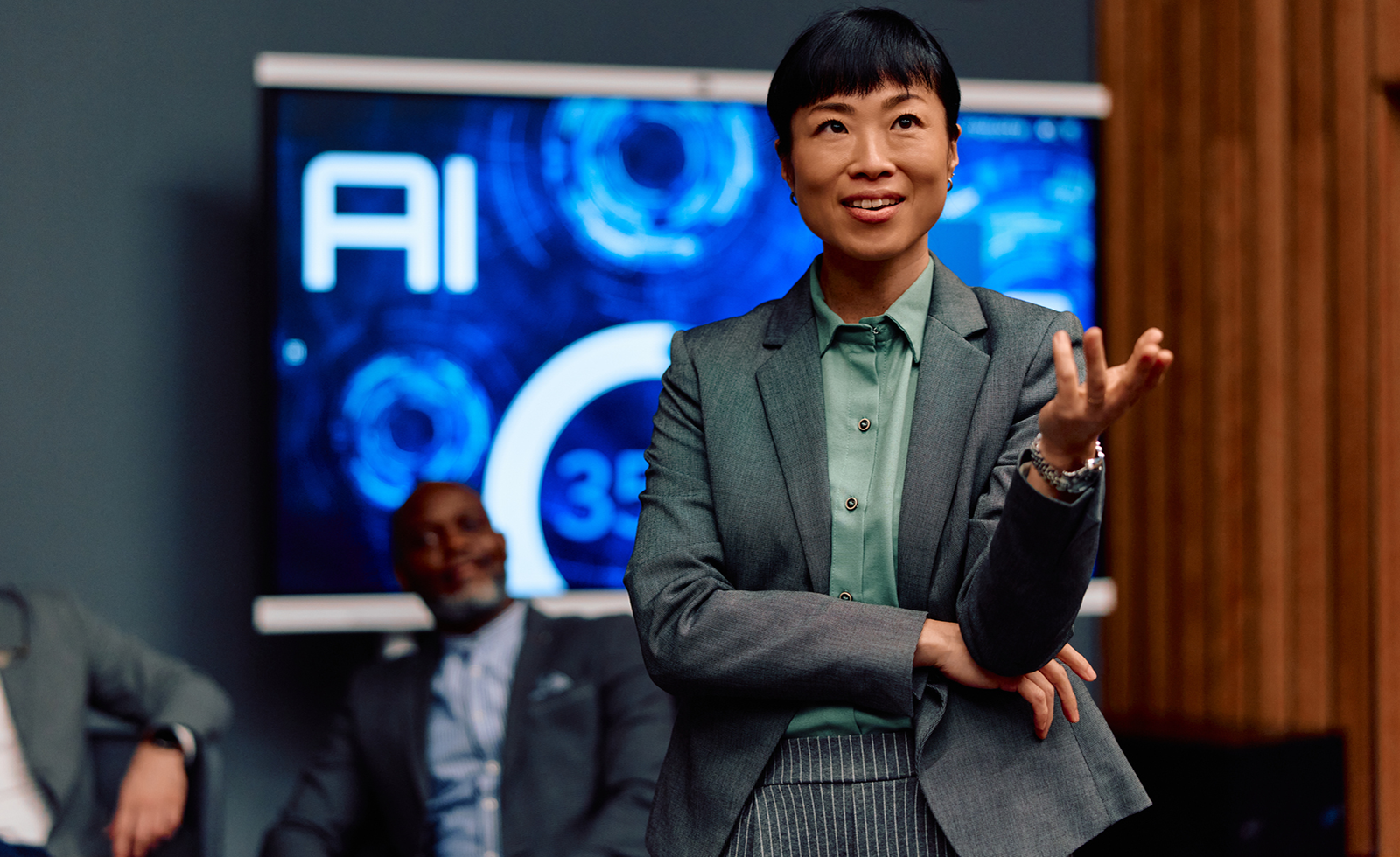 Asian businesswoman presenting AI concepts at business meeting.