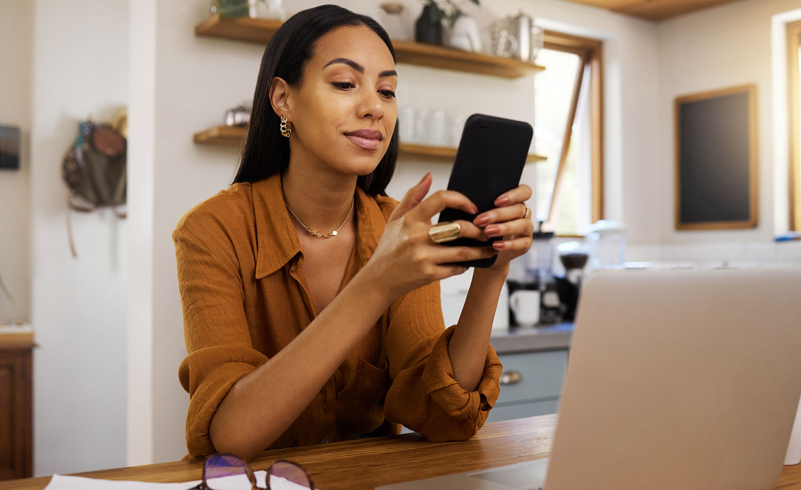 Young businesswoman looking at smartphone.